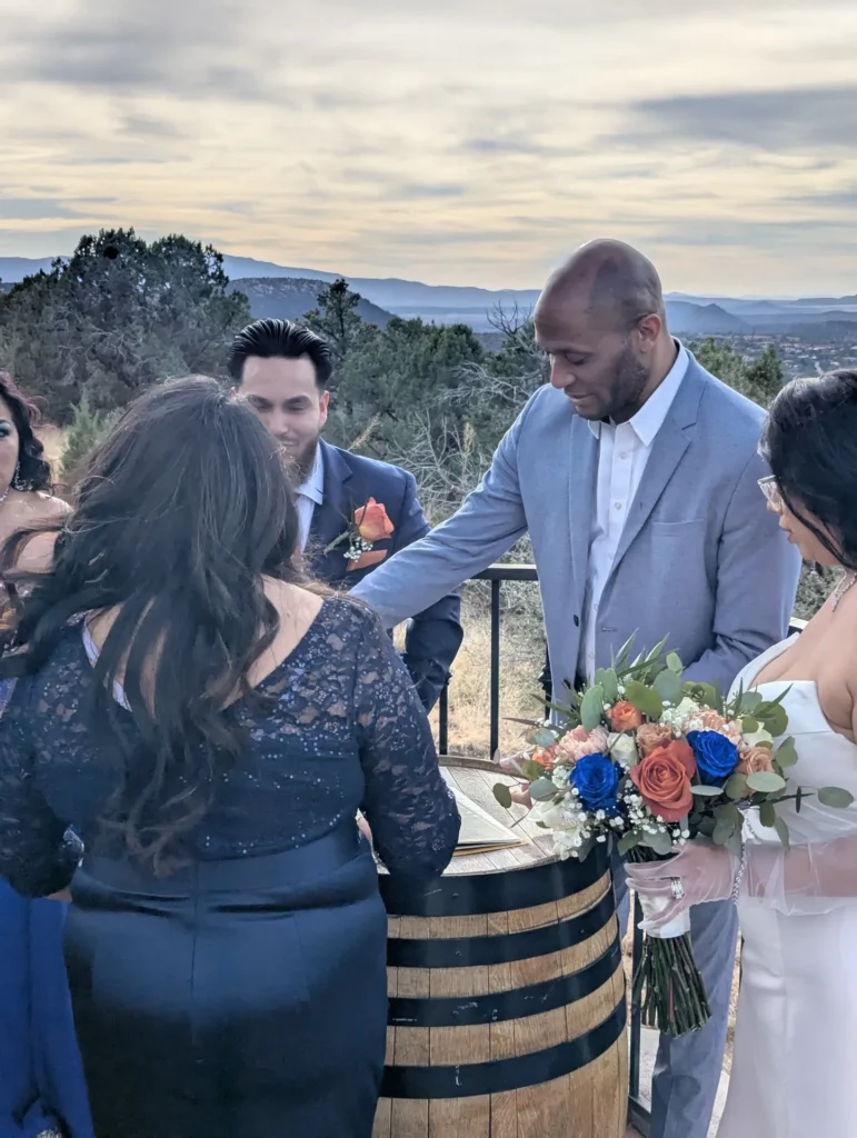 Wedding officiant greeting the couple at the signing table after a Sedona ceremony