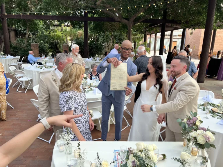 Wedding party celebrating together after the marriage license signing at an outdoor reception